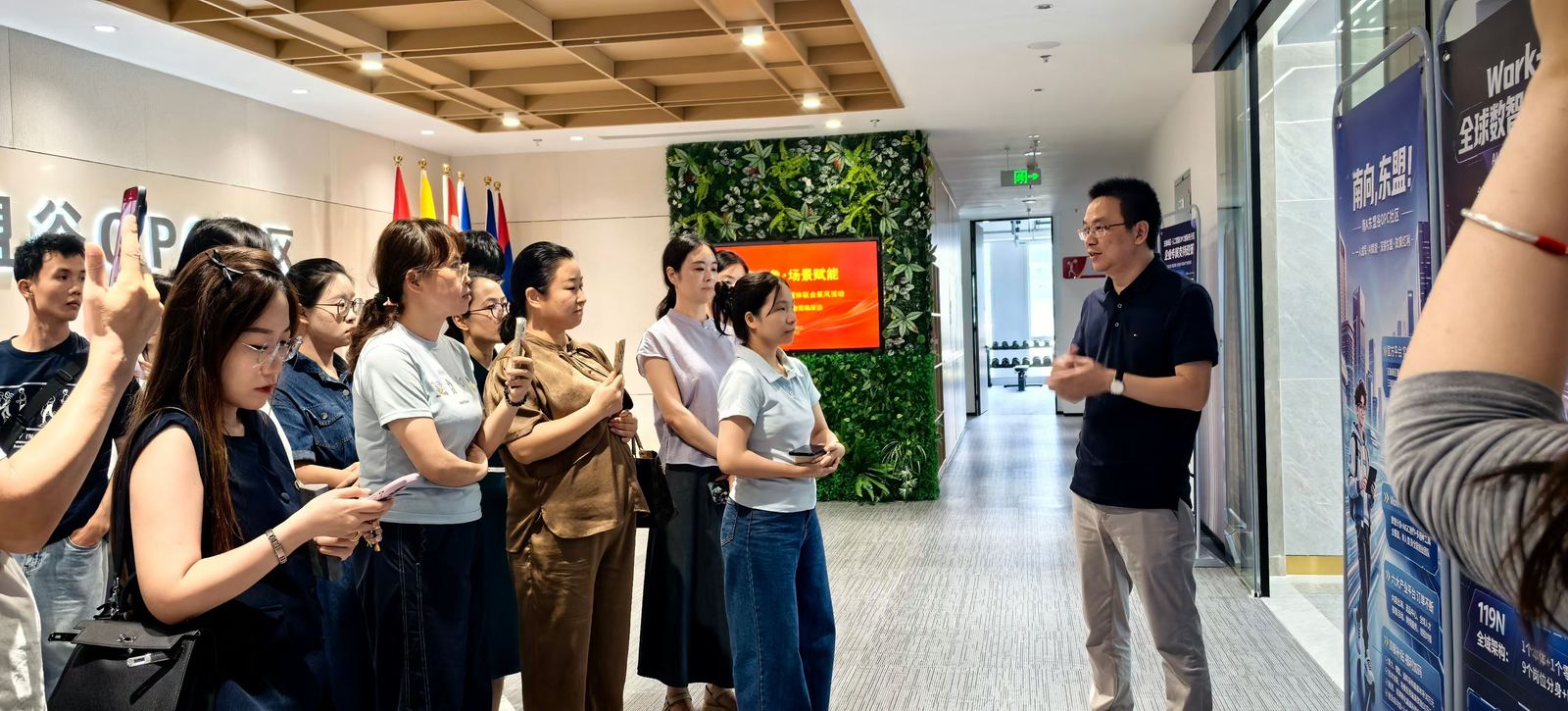 A person speaking with a group during a company visit.