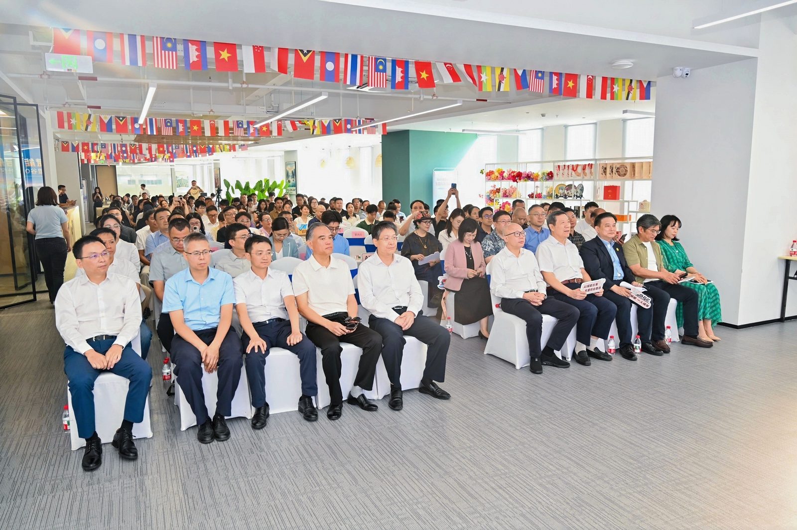 Audience seated beneath ASEAN flags at the 南A东盟谷 OPC Community launch in Nanning, 11 September 2026
